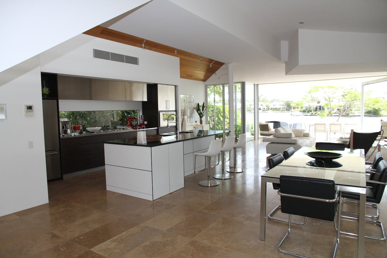 get-in-touch Spacious modern kitchen and living room with open design overlooking a scenic outdoor view.