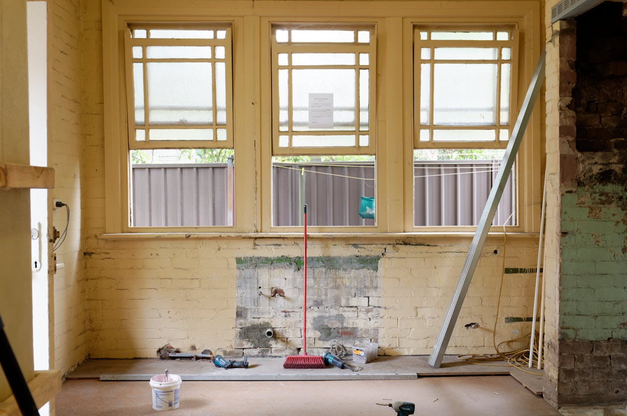 our-story An empty room featuring large windows, ready for renovation in Sydney, Australia.